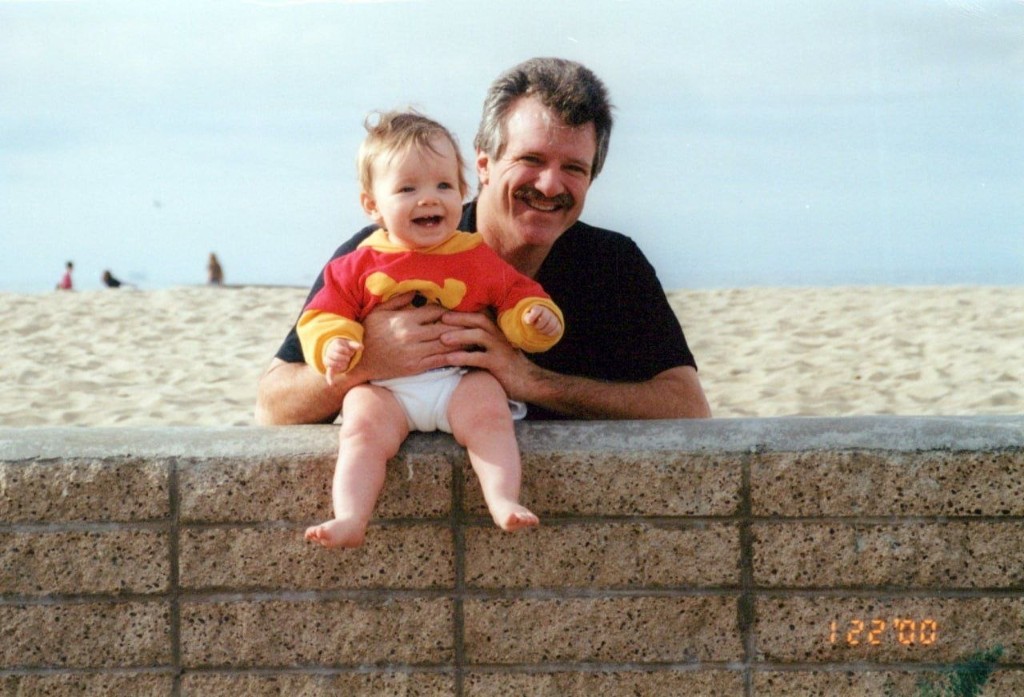 Brandon as a baby with his dad on the beach, January 2000